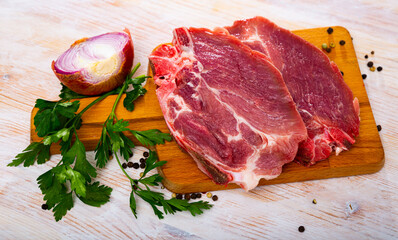 Raw pork chop on cutting board. High quality photo