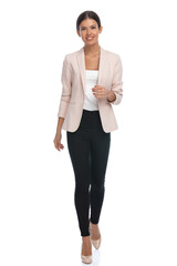 happy young businesswoman wearing pink jacket and smiling