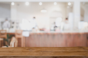 Wooden board empty table in front of blurred restaurant or coffee shop background. can be used for display or montage your products.Mock up for display of product.