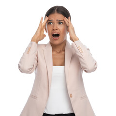 disturbed young female holding hands to forehead and screaming