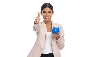 brunette attractive woman making thumbs up gesture and showing piggy bank