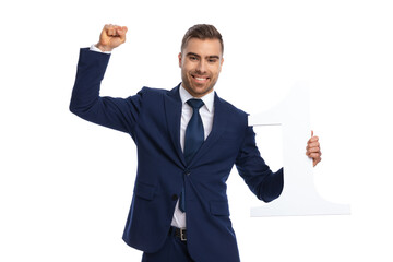 portrait of proud young man holding fist in the air and celebrating victory