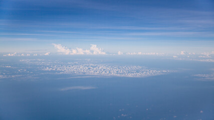 Aerial view of Blue sky and Cloud Top view from airplane window,Nature background. Sky and clouds.