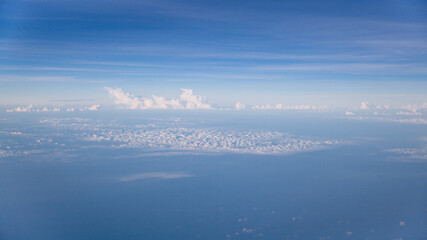 Fototapeta premium Aerial view of Blue sky and Cloud Top view from airplane window,Nature background. Sky and clouds.