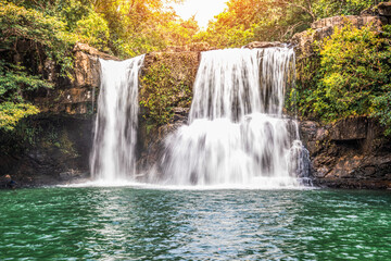 Fototapeta na wymiar Beautiful waterfall with sunlight in jungle, Khlong Chao waterfall in Ko kood island, Thailand