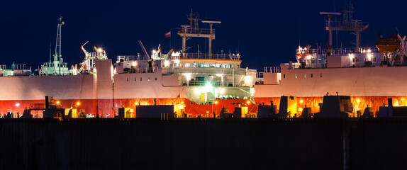 Obraz premium SHIPYARD - Two ships for the transport of cars in a repair dock 
