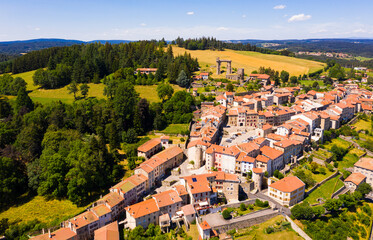 Fototapeta na wymiar View from drone of houses of village Allegre and ruined castle in alpine valley at sunny summer day