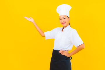 Portrait beautiful young asian woman in chef or cook uniform with hat