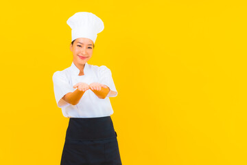 Portrait beautiful young asian woman in chef or cook uniform with hat