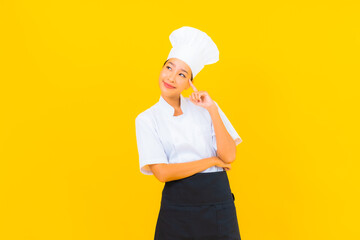 Portrait beautiful young asian woman in chef or cook uniform with hat