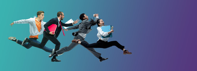 Evening. Happy office workers jumping and dancing in casual clothes or suit isolated on gradient...