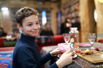 Kid eating ice cream in restaurant