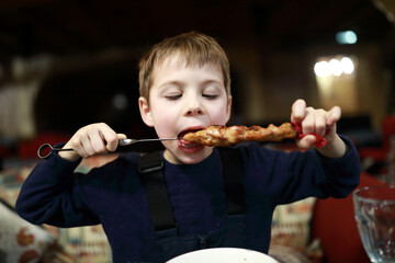 Kid eating kebab