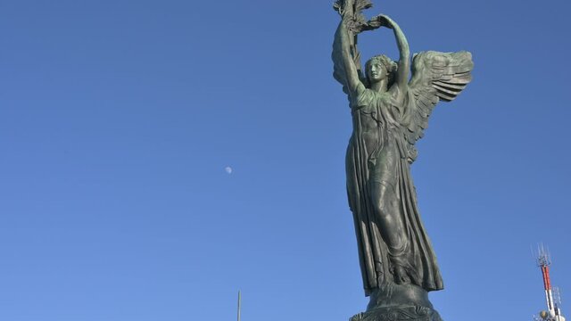 Turin, Piedmont, Italy. January 2020. Tilt footage on the Vittoria lighthouse, is a bronze statue, placed on the top of the Parco della Rimembranza, Maddalena hill. Antennas behind him.