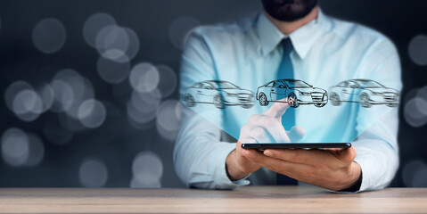 man holding tablet with car models