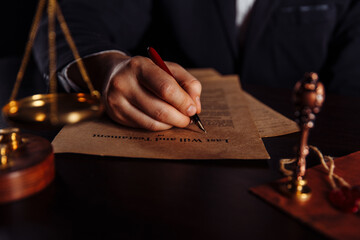 Man signing a Last Will and Testament document.
