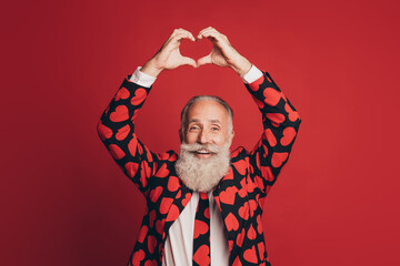 Photo of affectionate retired old man show heart shape raise hands wear heart print tux tie...