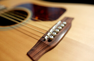 leisure, music and musical instruments concept - close up of acoustic guitar strings