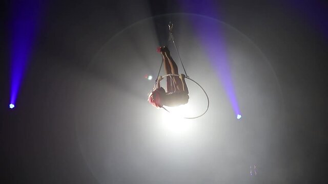 Aerial acrobat on the stage of the circus.