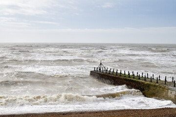 Waves crashing on the beach on a stormy winter day