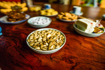 View of Vietnamese food for Tet holiday in spring, jam is traditional food and teapot set on lunar new year. Dried fruit and jam as tradition dessert - Mut Tet on wooden table.