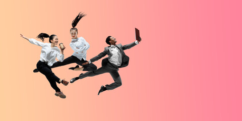 Fototapeta na wymiar Pink. Happy office workers jumping and dancing in casual clothes or suit isolated on gradient neon fluid background. Business, start-up, working open-space, motion, action concept. Creative collage.