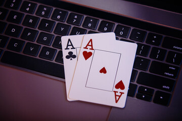 Online gambling theme. Aces on a laptop's keyboard.