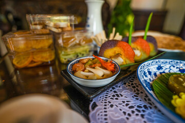 View of Vietnamese food for Tet holiday in spring, jam is traditional food and teapot set on lunar new year. Dried fruit and jam as tradition dessert - Mut Tet on wooden table.
