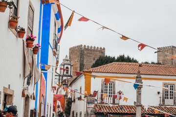 OBIDOS, PORTUGAL - 08-09-2020 : Souvenir shops and colorful narrow streets of the medieval portuguese city of &Oacute;bidos, a tourist attraction in central Portugal. famous destination for its architecture