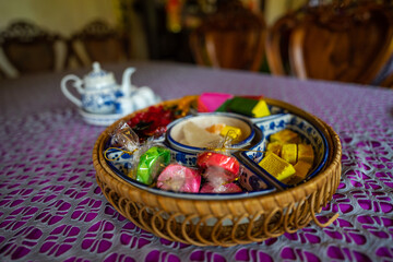 Obraz na płótnie Canvas View of Vietnamese food for Tet holiday in spring, jam is traditional food and teapot set on lunar new year. Dried fruit and jam as tradition dessert - Mut Tet on wooden table.