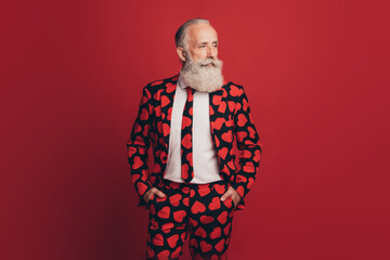 Photo of self-assured bearded man hands pockets cool look side empty space wear heart print tux...