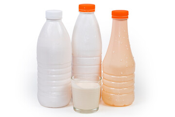 Plastic bottles and glass of various drinkable fermented dairy products