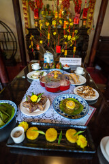 View of Vietnamese food for Tet holiday in spring, jam is traditional food and teapot set on lunar new year. Dried fruit and jam as tradition dessert - Mut Tet on wooden table.