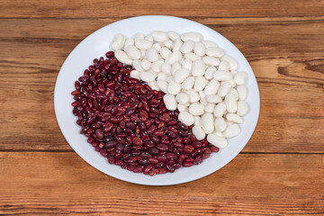 White and red kidney beans on dish on rustic table