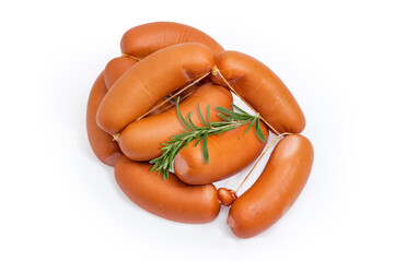 Pile of the uncooked short thick sausages with rosemary twig