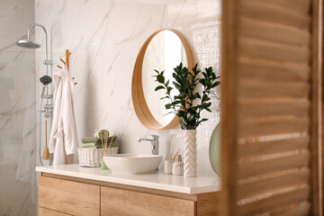 Modern bathroom interior with stylish mirror and vessel sink