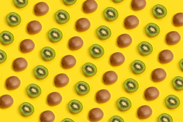 Pattern of kiwi fruit slice isolated on yellow background.