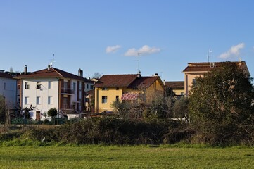 Fototapeta na wymiar Houses in a suburb behind a lawn (Pesaro, Italy, Europe)