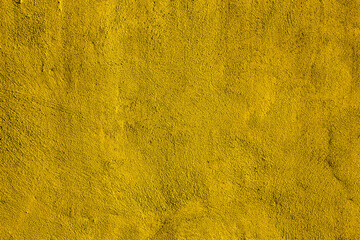 Yellow colored abstract wall background with textures of different shades of gold or yellow