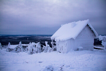 Hidden Santas cottage covered in snow in the ski slopes on the mountain at Levi ski center,...