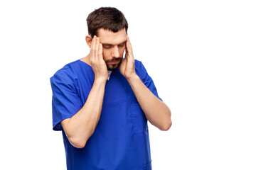 healthcare, profession and medicine concept - stressed doctor or male nurse in blue uniform over white background
