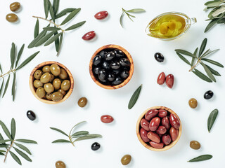 Set of green olives, black olives and red kalmata olives and extra virgin olive oil on white...