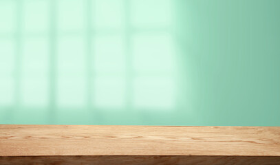 Empty table top made of natural wood, light.rays from the window on the background of the wall. For product demonstration