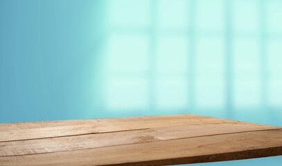 Empty table top made of natural wood, light.rays from the window on the background of the wall. For...