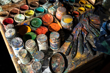 Acrylic paint cans and knives on the table