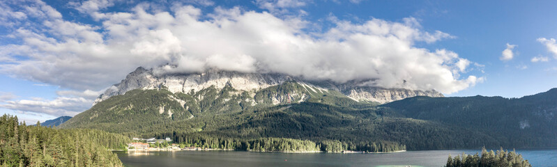 Panoramic aerial view of Zugspitze mountain heavy fog by Eibsee Lake in Germany