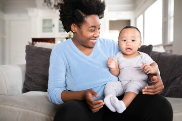 Cheerful African American mother looking at her son