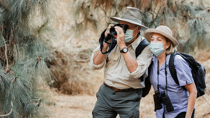Naklejka na ściany i meble Active senior couple enjoying the beauty of nature during Covid-19 pandemic