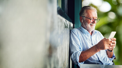 Elderly man watching online movie from his phone