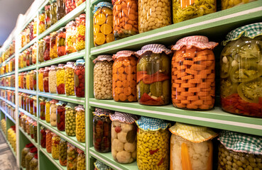 Lots of colorful pickles in bottles, jars of pickles, different pickled vegetables ...